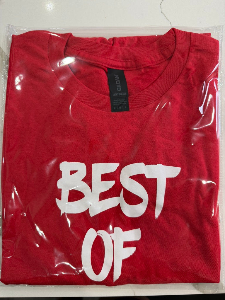 Red t-shirt with 'BEST OF' text in white, folded and in clear plastic packaging.